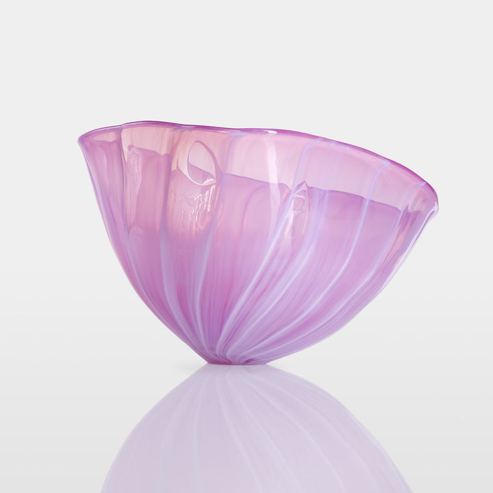 Delicately sculpted blown glass bowl in soft lilac and pink tones, with fluid contours and a translucent finish, displayed against a clean white background.