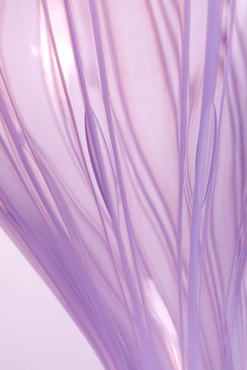 Elegant hand-blown glass sculpture with a balloon-like silhouette and gently tapered base, featuring soft lavender and pink tones with delicate swirling lines throughout.