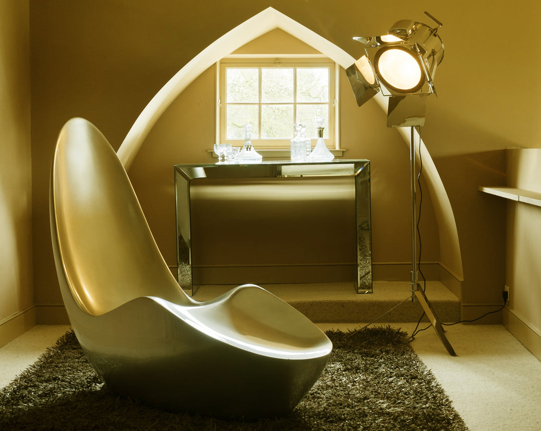 “Caillou Chaise – Metallic Wet Spray” by Ben Rousseau – a sculptural chaise inspired by 1960s grand tourers, hand-shaped in composite with a high-gloss metallic lacquered finish in white, lime, gold, or silver. A fusion of luxury design and form.

