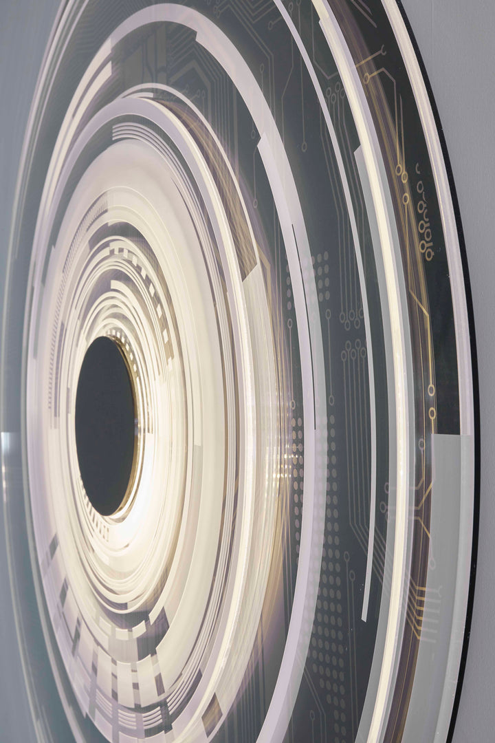 The Portal by Ben Rousseau – a circular illuminated artwork blending acrylic, LED, and brass. Featuring concentric rings and circuit-inspired patterns in gold, white, and black, it transforms technology into art and light into architectural sculpture.
