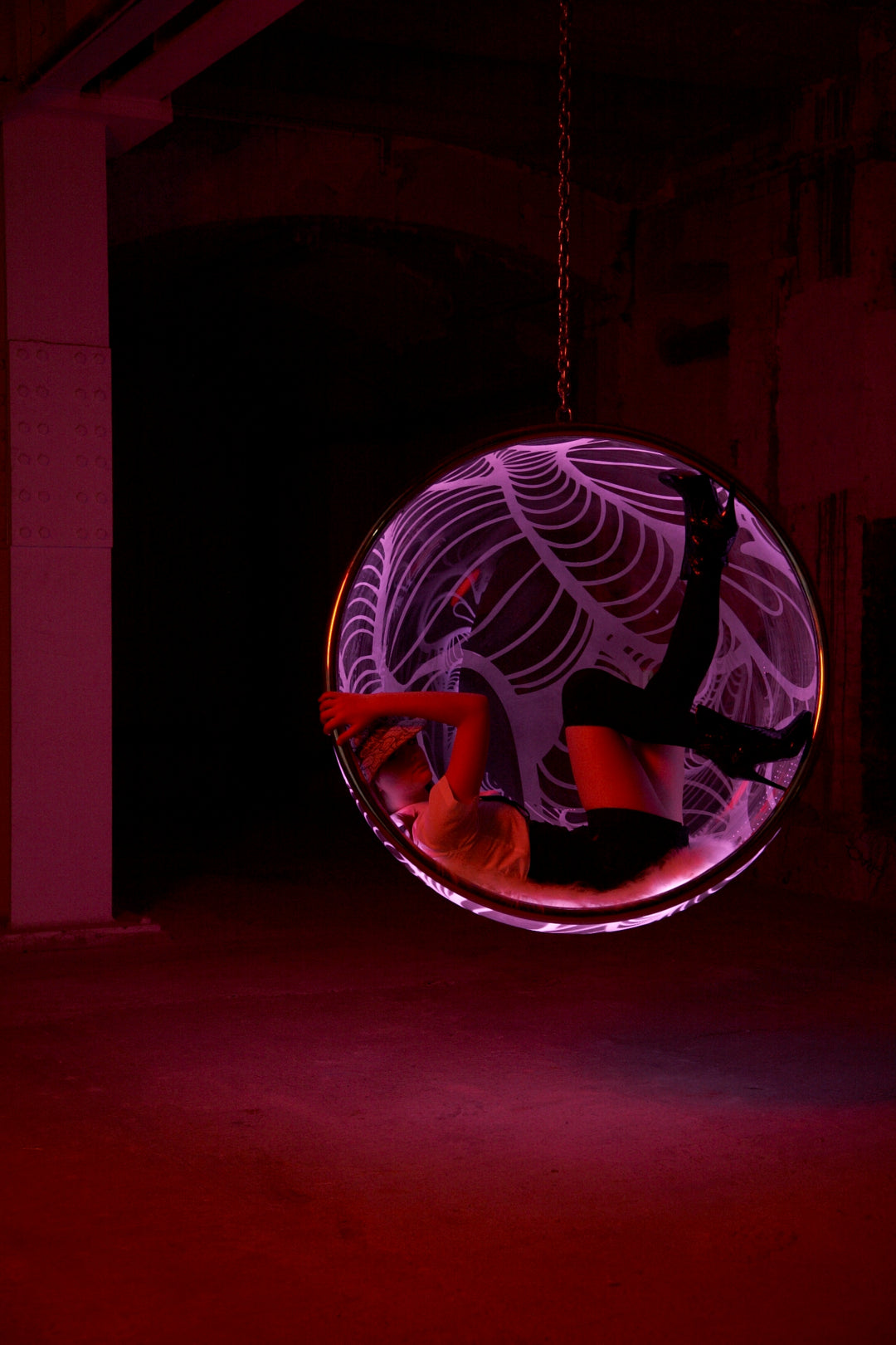 Ben Rousseau, Illuminated Bubble Chair – a limited-edition hanging sphere with engraved acrylic, vibrant pink-purple LED glow, and Mongolian sheepskin cushion featuring INSA’s signature pattern. A cocoon-like statement chair blending art, comfort, and sensory light.