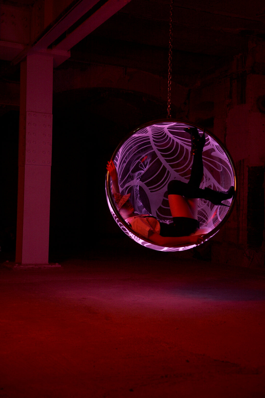 Ben Rousseau, Illuminated Bubble Chair – a limited-edition hanging sphere with engraved acrylic, vibrant pink-purple LED glow, and Mongolian sheepskin cushion featuring INSA’s signature pattern. A cocoon-like statement chair blending art, comfort, and sensory light.