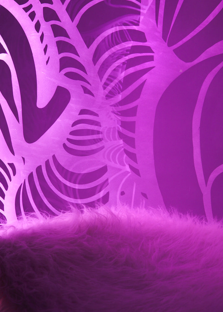 Ben Rousseau, Illuminated Bubble Chair – a limited-edition hanging sphere with engraved acrylic, vibrant pink-purple LED glow, and Mongolian sheepskin cushion featuring INSA’s signature pattern. A cocoon-like statement chair blending art, comfort, and sensory light.