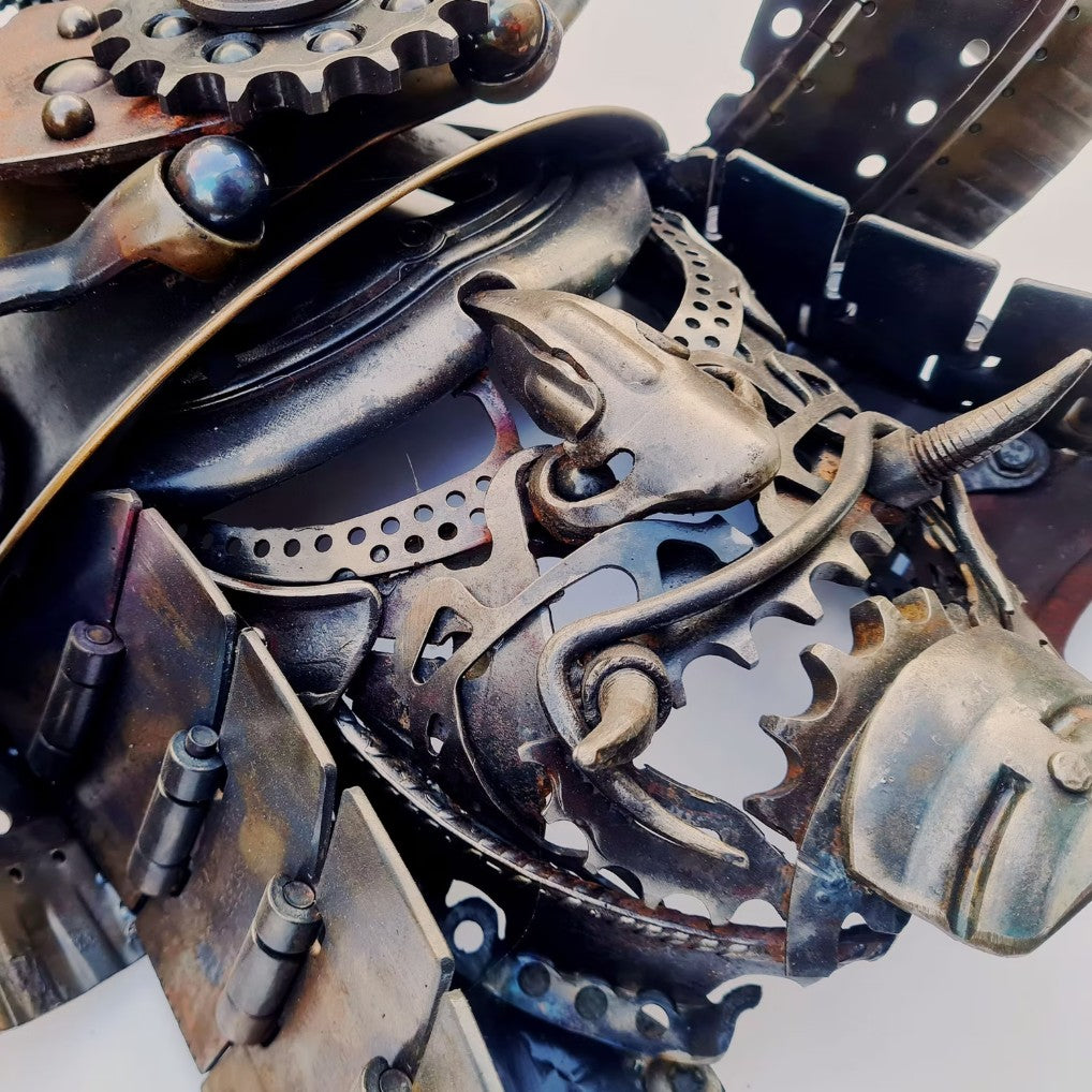 Samurai-inspired helmet sculpture crafted from reclaimed metal with intricate steampunk detailing.