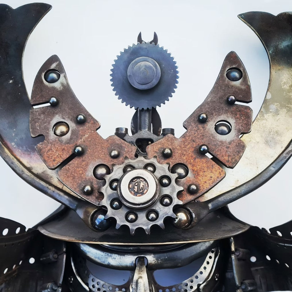Samurai-inspired helmet sculpture crafted from reclaimed metal with intricate steampunk detailing.