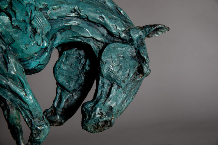 Bronze sculpture of two intertwined horse heads with elongated ears, rendered in a turquoise verdigris finish, symbolising love and hope, mounted on a slate base.