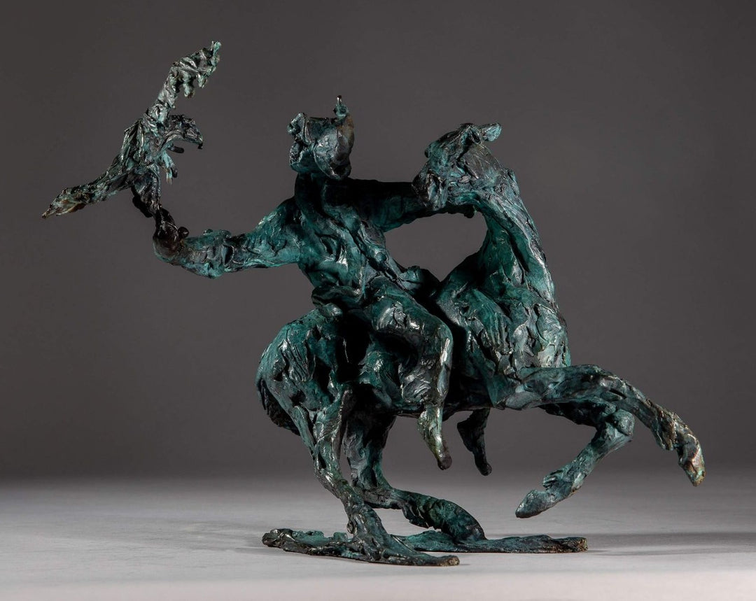 Bronze sculpture of a Mongolian hunter on horseback, shown mid-motion with an eagle perched on the rider’s outstretched arm. The piece features dynamic movement and expressive texture, finished in a rich turquoise verdigris patina.
