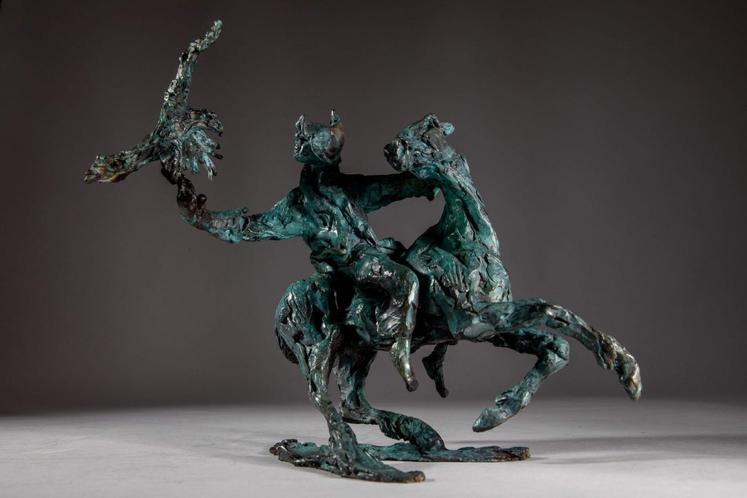 Bronze sculpture of a Mongolian hunter on horseback, shown mid-motion with an eagle perched on the rider’s outstretched arm. The piece features dynamic movement and expressive texture, finished in a rich turquoise verdigris patina.