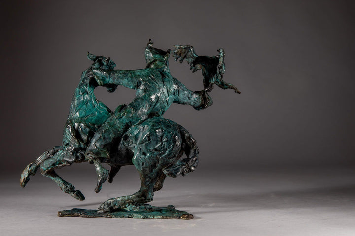 Bronze sculpture of a Mongolian hunter on horseback, shown mid-motion with an eagle perched on the rider’s outstretched arm. The piece features dynamic movement and expressive texture, finished in a rich turquoise verdigris patina.