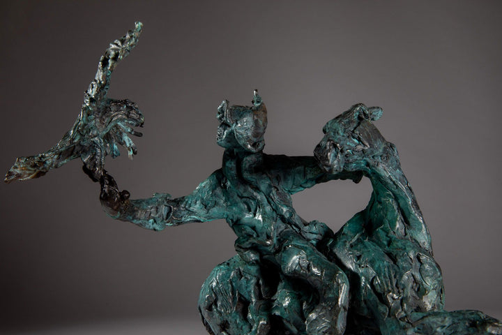 Bronze sculpture of a Mongolian hunter on horseback, shown mid-motion with an eagle perched on the rider’s outstretched arm. The piece features dynamic movement and expressive texture, finished in a rich turquoise verdigris patina.