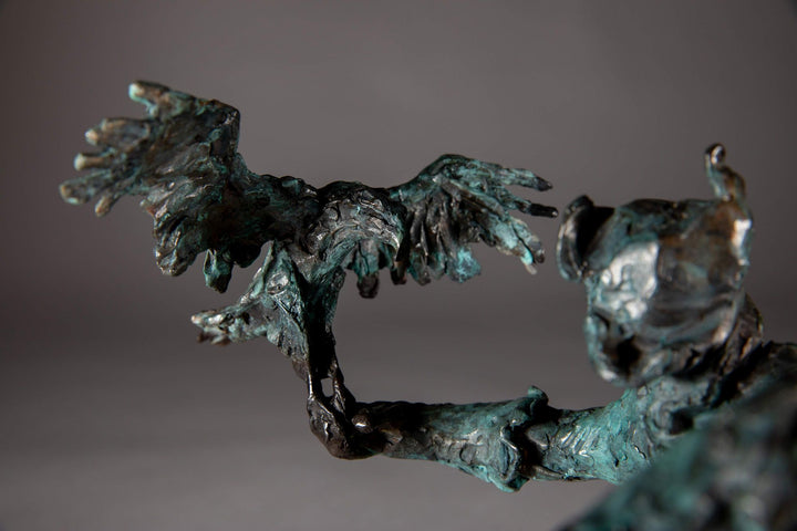 Bronze sculpture of a Mongolian hunter on horseback, shown mid-motion with an eagle perched on the rider’s outstretched arm. The piece features dynamic movement and expressive texture, finished in a rich turquoise verdigris patina.