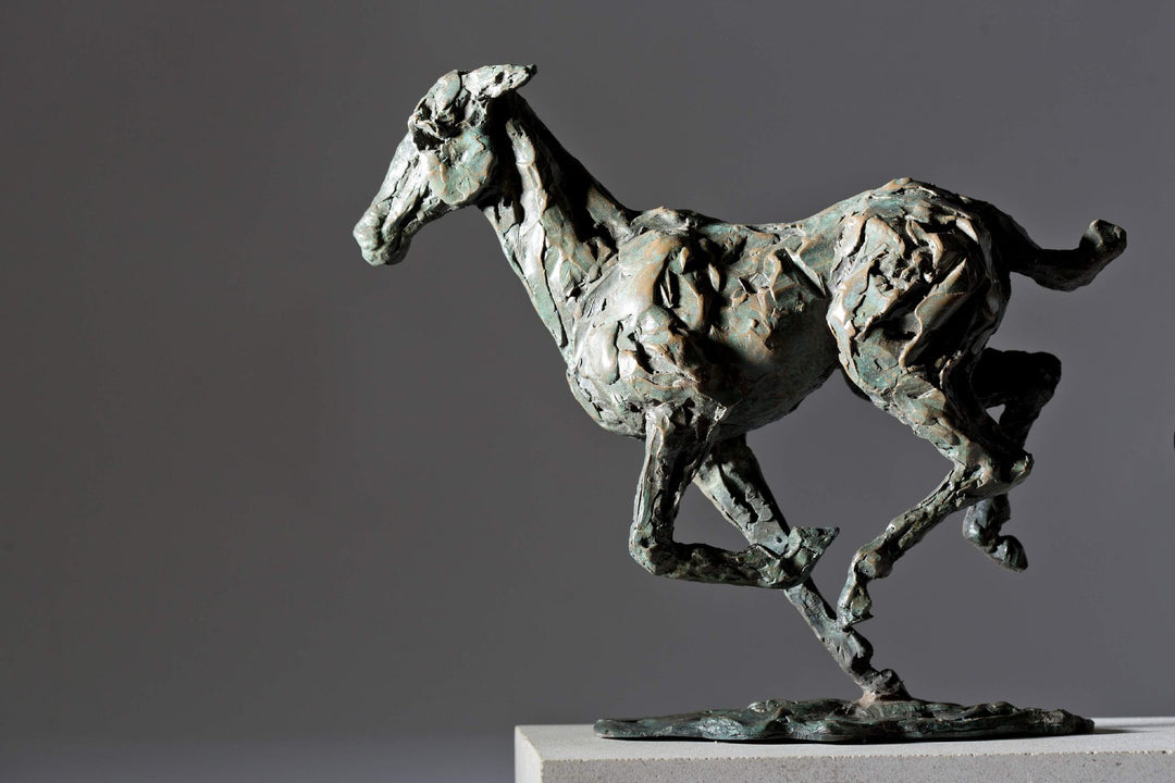 Bronze sculpture of three galloping horses mounted on a Portland stone base, capturing the fluid motion and changing form of equine movement in a verdigris finish.
