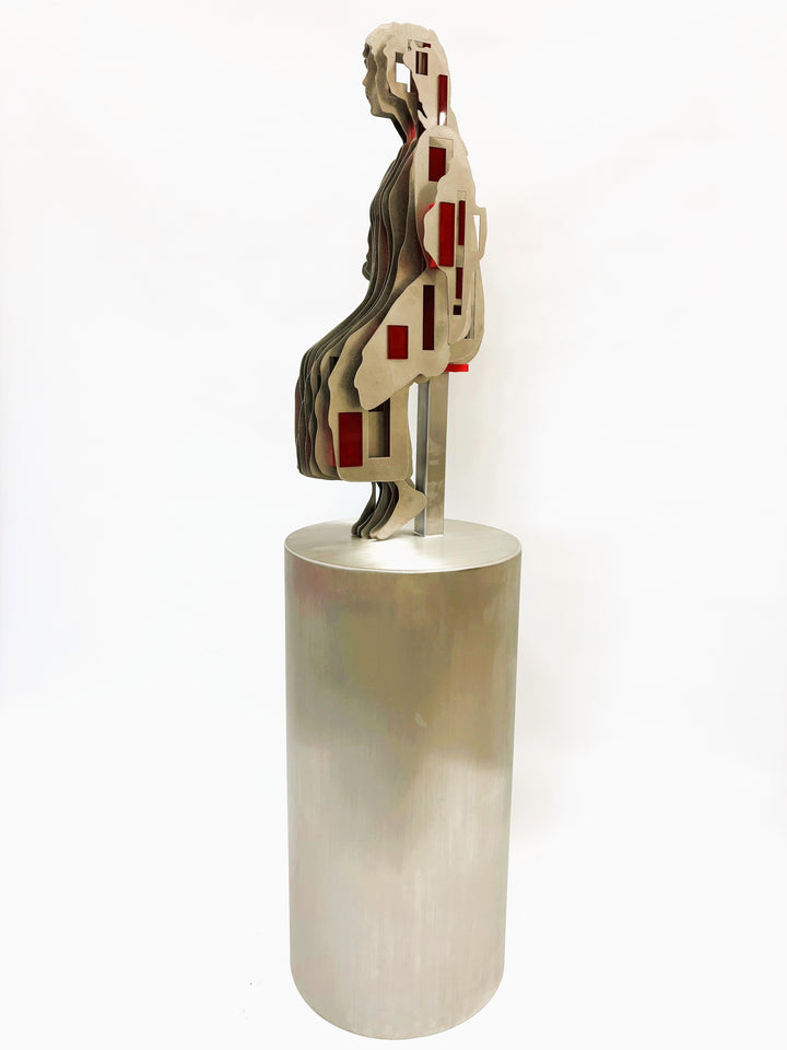 Sculpture titled Seated Girl I by Tom Hiscox, composed of layered stainless steel with red resin inserts forming a stylised seated female figure, shown from multiple angles on a brushed circular base.