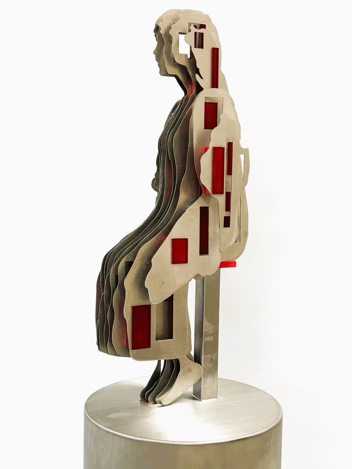 Sculpture titled Seated Girl I by Tom Hiscox, composed of layered stainless steel with red resin inserts forming a stylised seated female figure, shown from multiple angles on a brushed circular base.