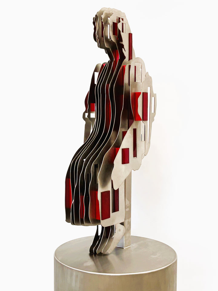 Sculpture titled Seated Girl I by Tom Hiscox, composed of layered stainless steel with red resin inserts forming a stylised seated female figure, shown from multiple angles on a brushed circular base.