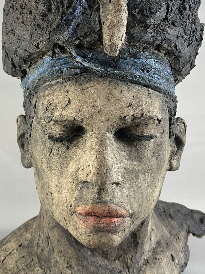 Limited edition ceramic sculpture Sleeping Gods II by Eve Shepherd, depicting a monumental hand-built head with closed eyes and a textured, symbolic crown, sculpted in earthy stone-grey tones with blue and mineral patina details, evoking myth, memory, and quiet power.