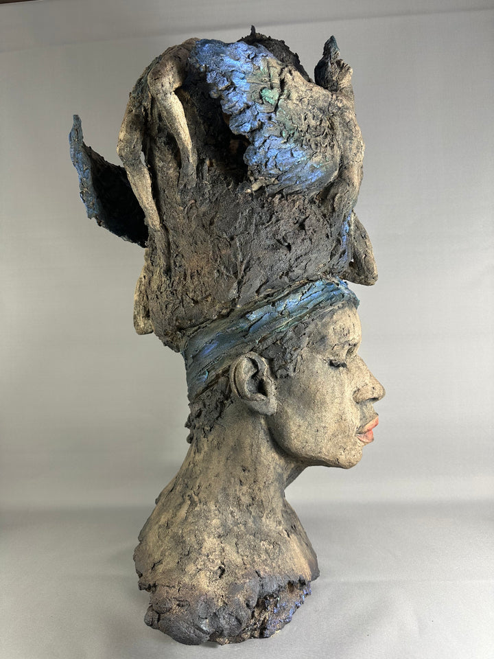 Limited edition ceramic sculpture Sleeping Gods II by Eve Shepherd, depicting a monumental hand-built head with closed eyes and a textured, symbolic crown, sculpted in earthy stone-grey tones with blue and mineral patina details, evoking myth, memory, and quiet power.