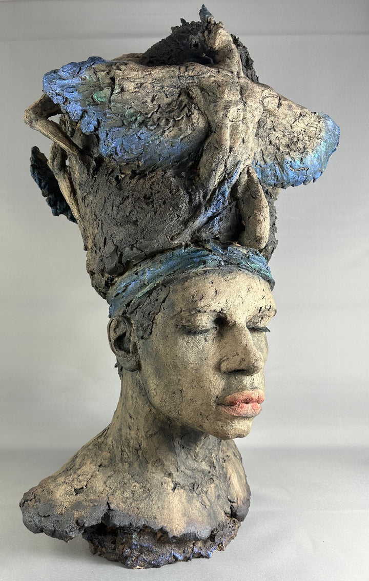 Limited edition ceramic sculpture Sleeping Gods II by Eve Shepherd, depicting a monumental hand-built head with closed eyes and a textured, symbolic crown, sculpted in earthy stone-grey tones with blue and mineral patina details, evoking myth, memory, and quiet power.