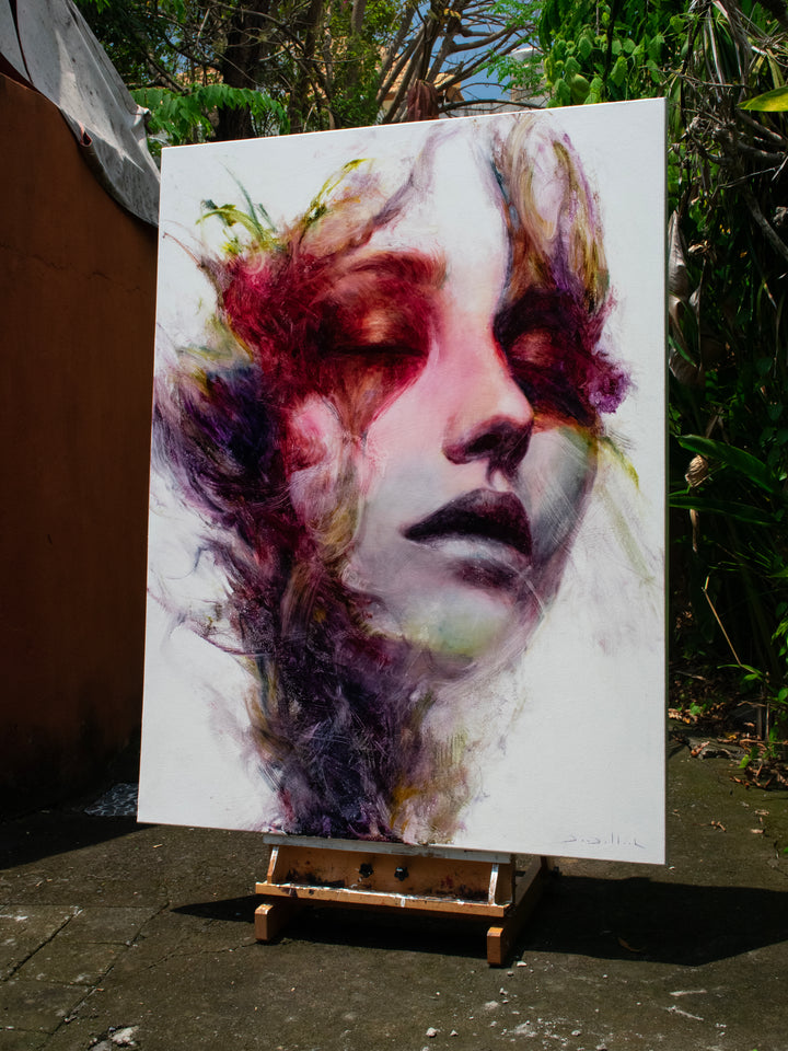 Large oil on canvas portrait by Dan Bullock, titled Spectrum. A dreamlike female face with eyes closed, surrounded by expressive swirls of crimson, violet, emerald, gold, and deep shadow tones, blending realism with abstraction.