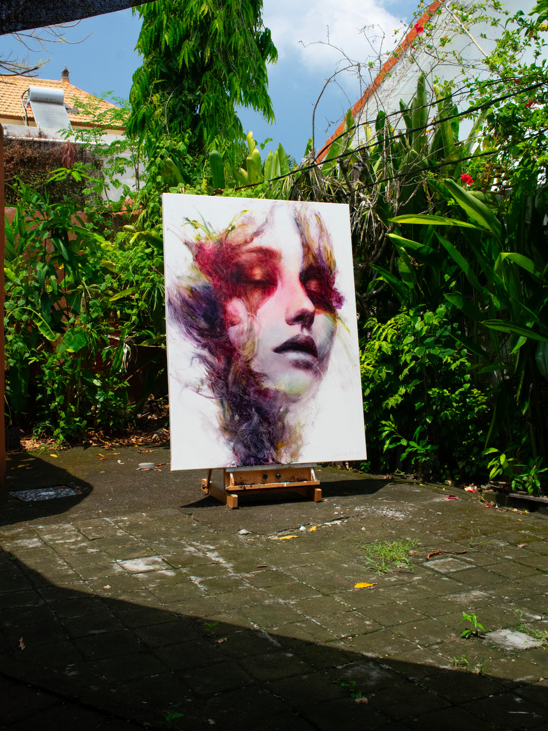 Large oil on canvas portrait by Dan Bullock, titled Spectrum. A dreamlike female face with eyes closed, surrounded by expressive swirls of crimson, violet, emerald, gold, and deep shadow tones, blending realism with abstraction.