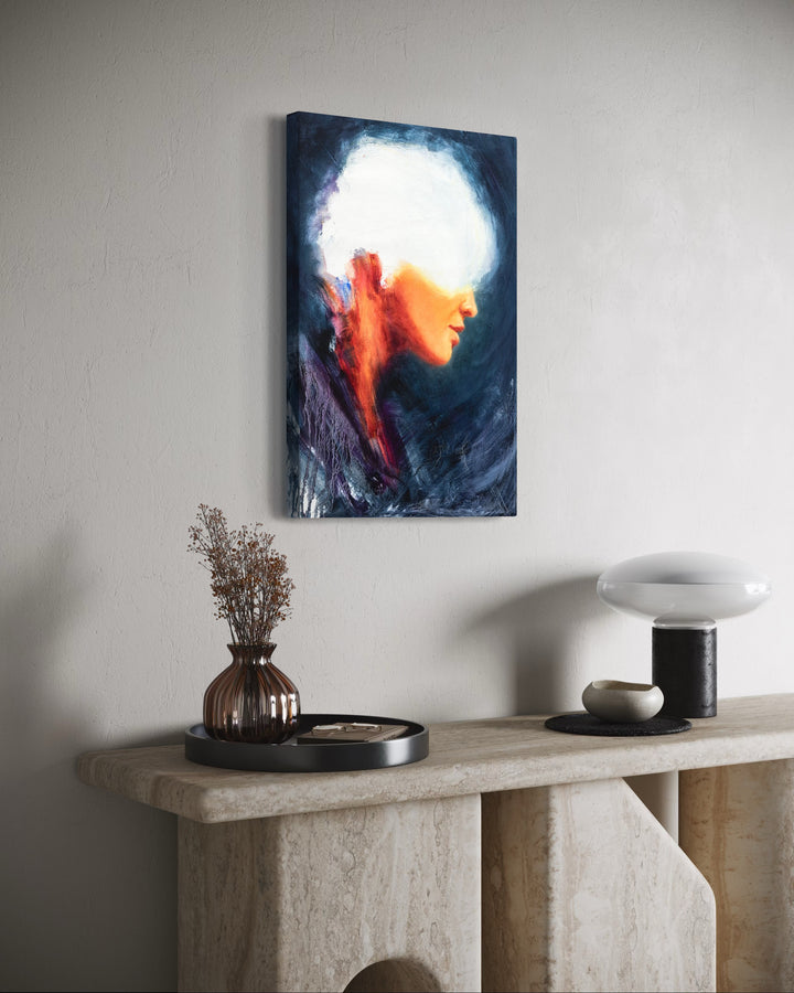 Oil on canvas painting by Dan Bullock, titled Spellbound. A semi-abstract portrait of a woman in profile, her face softly lit in warm peach and orange tones, contrasted against deep navy and indigo brushwork. The upper head dissolves into white light, creating a sense of mystery and transcendence. The expressive textures and layered brushstrokes convey both fragility and strength.
