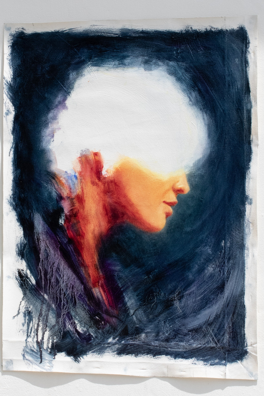 Oil on canvas painting by Dan Bullock, titled Spellbound. A semi-abstract portrait of a woman in profile, her face softly lit in warm peach and orange tones, contrasted against deep navy and indigo brushwork. The upper head dissolves into white light, creating a sense of mystery and transcendence. The expressive textures and layered brushstrokes convey both fragility and strength.