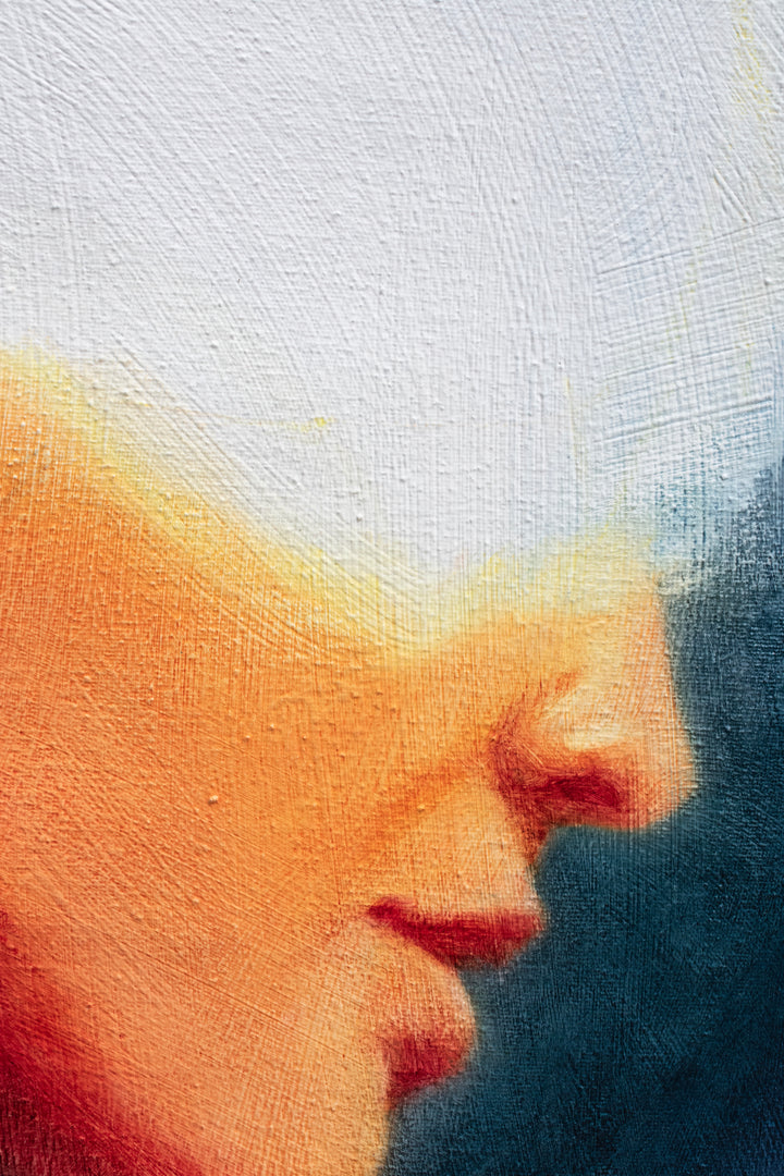 Oil on canvas painting by Dan Bullock, titled Spellbound. A semi-abstract portrait of a woman in profile, her face softly lit in warm peach and orange tones, contrasted against deep navy and indigo brushwork. The upper head dissolves into white light, creating a sense of mystery and transcendence. The expressive textures and layered brushstrokes convey both fragility and strength.