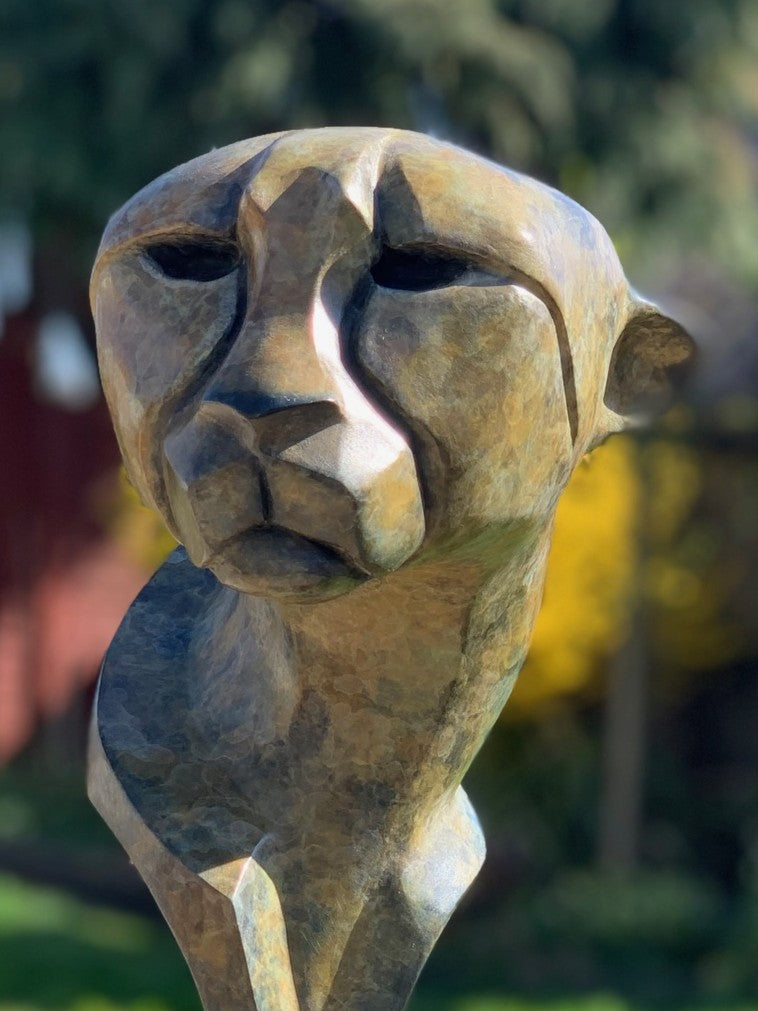 Marie Ackers Spirit of Savannah bronze sculpture, limited edition of 8. Stylised cheetah head and shoulders with flowing geometric lines, patinated in earthy green and bronze tones, evoking the spirit and elegance of Africa’s great cats.