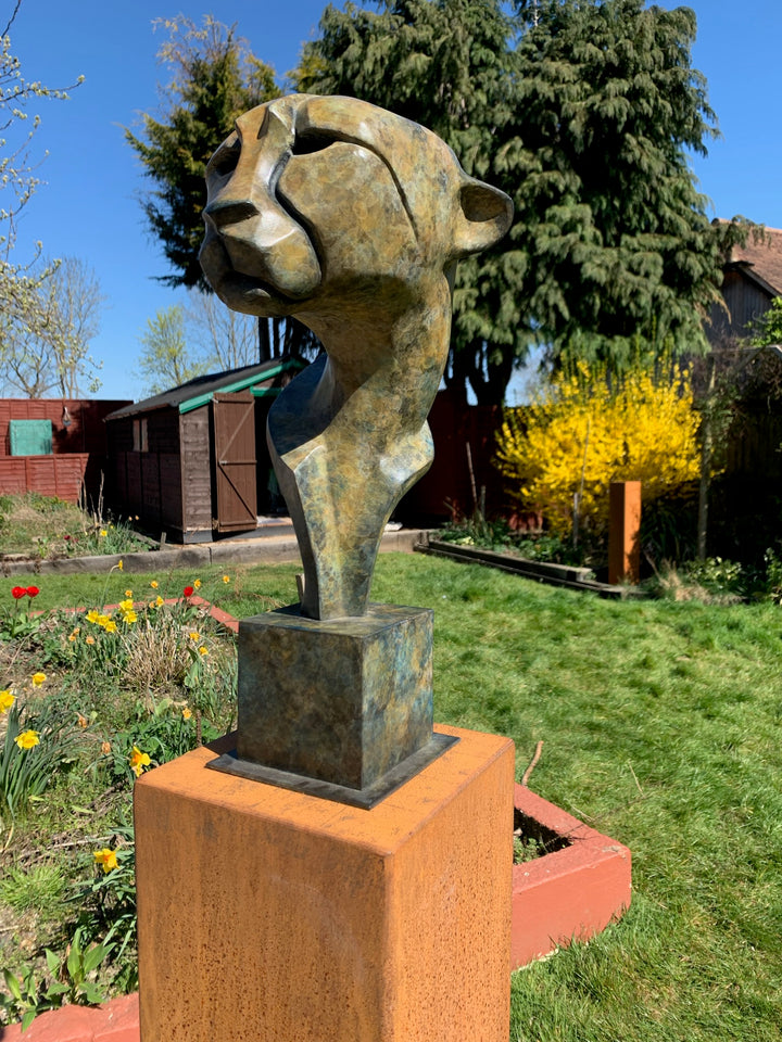 Marie Ackers Spirit of Savannah bronze sculpture, limited edition of 8. Stylised cheetah head and shoulders with flowing geometric lines, patinated in earthy green and bronze tones, evoking the spirit and elegance of Africa’s great cats.