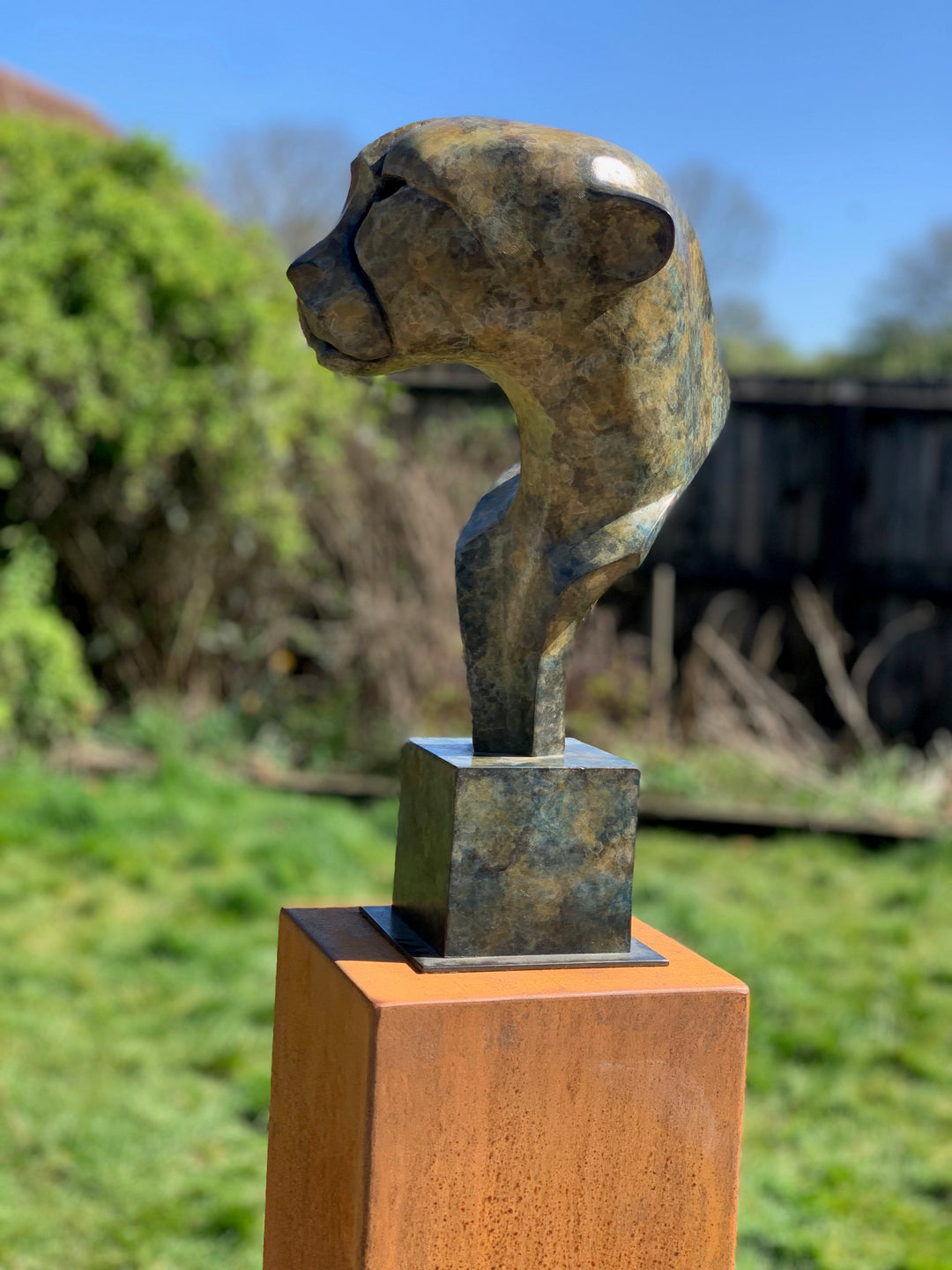 Marie Ackers Spirit of Savannah bronze sculpture, limited edition of 8. Stylised cheetah head and shoulders with flowing geometric lines, patinated in earthy green and bronze tones, evoking the spirit and elegance of Africa’s great cats.