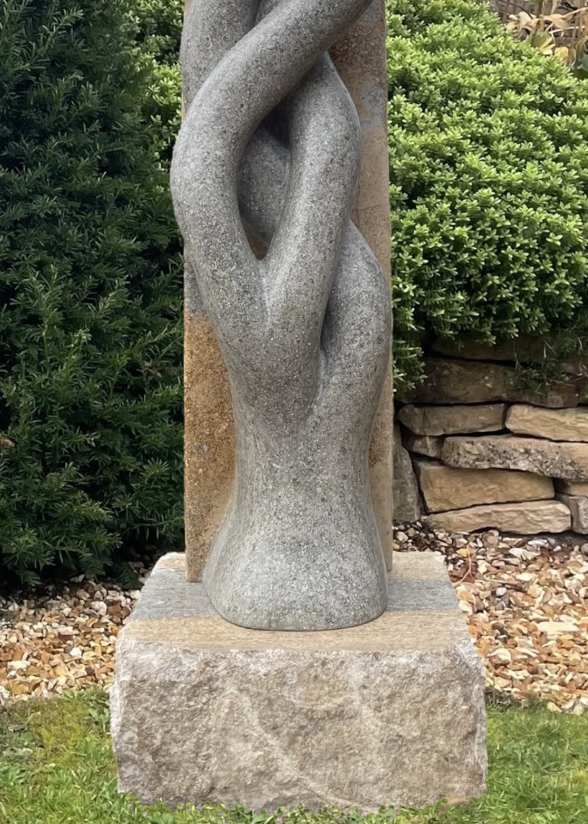 Sporangia by Martin Cash — a one-off stone sculpture carved from a single block of blue and buff Ancaster Weatherbed. The intertwined organic forms rise gracefully from an Ancaster plinth, symbolising unity and growth, designed as a contemporary statement for gardens or public spaces.