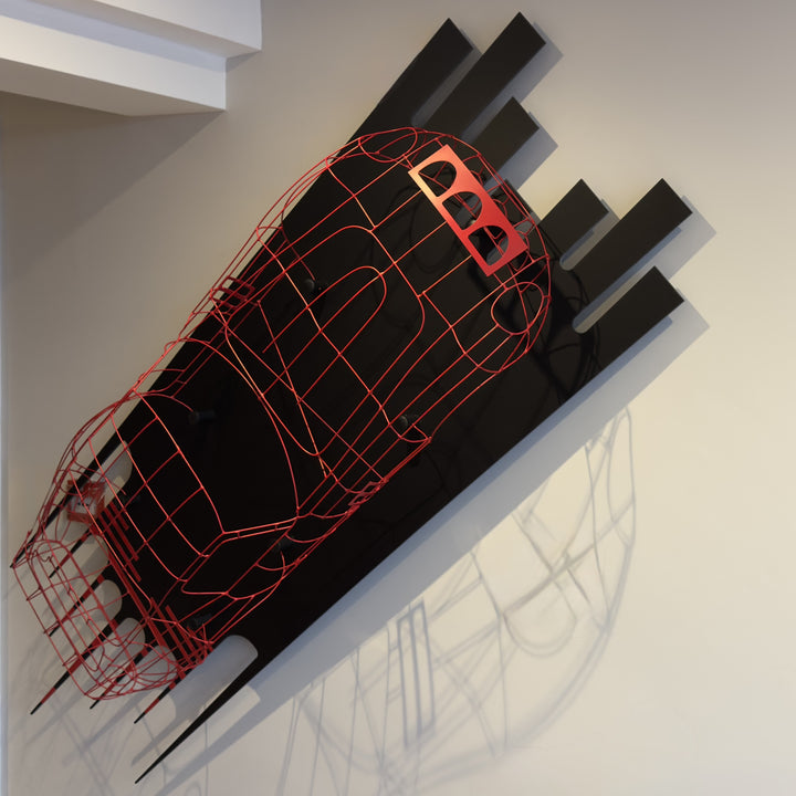 Handcrafted red wire sculpture of the Ferrari 250 GTO by Chris Twitchell, inspired by the original coachbuilder’s buck used to form the legendary 1962 Series 1 body. Finished in Rosso Chiaro red, this intricate wall-mounted artwork captures the elegance, form, and aerodynamics of Scaglietti’s design through sculptural craftsmanship and precision engineering.