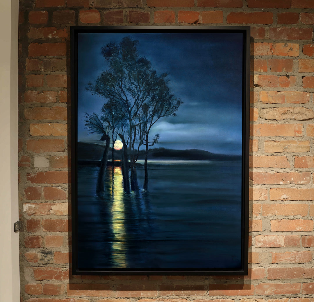 Moonrise by Ewan Story – oil on canvas painting of silhouetted trees rising from still water beneath a deep indigo night sky, a golden moon reflecting across dark blue tones, atmospheric contemporary landscape wall art from The Collection.