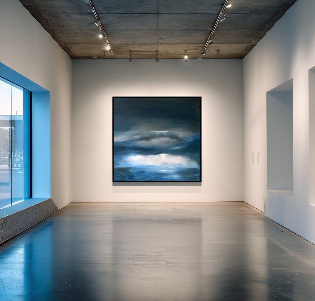 Pelagic by Ewan Story – large square oil on canvas seascape in deep blue, navy and slate grey tones, with layered storm clouds and soft white light breaking over a restless ocean horizon, contemporary atmospheric wall art from The Collection.