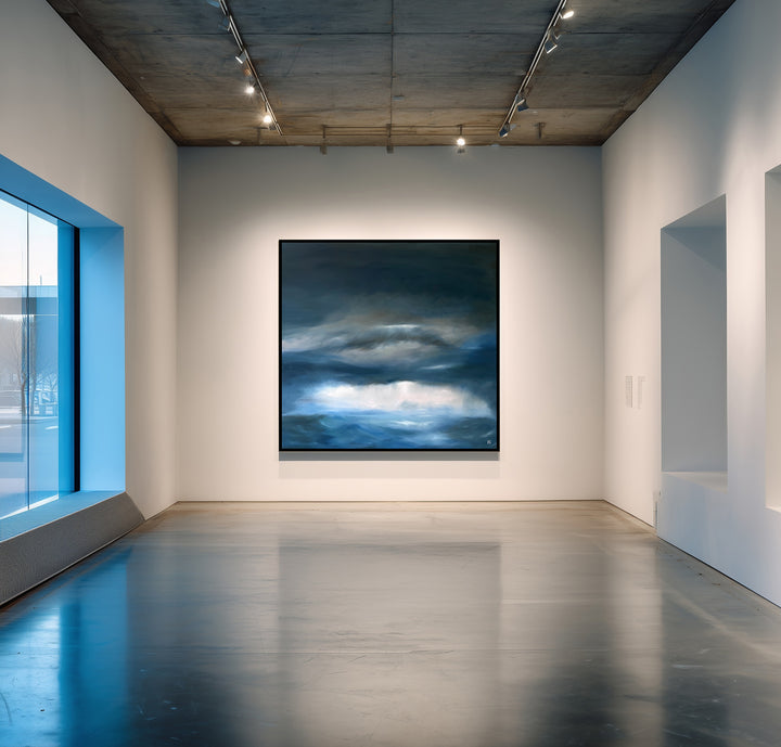 Pelagic by Ewan Story – large square oil on canvas seascape in deep blue, navy and slate grey tones, with layered storm clouds and soft white light breaking over a restless ocean horizon, contemporary atmospheric wall art from The Collection.