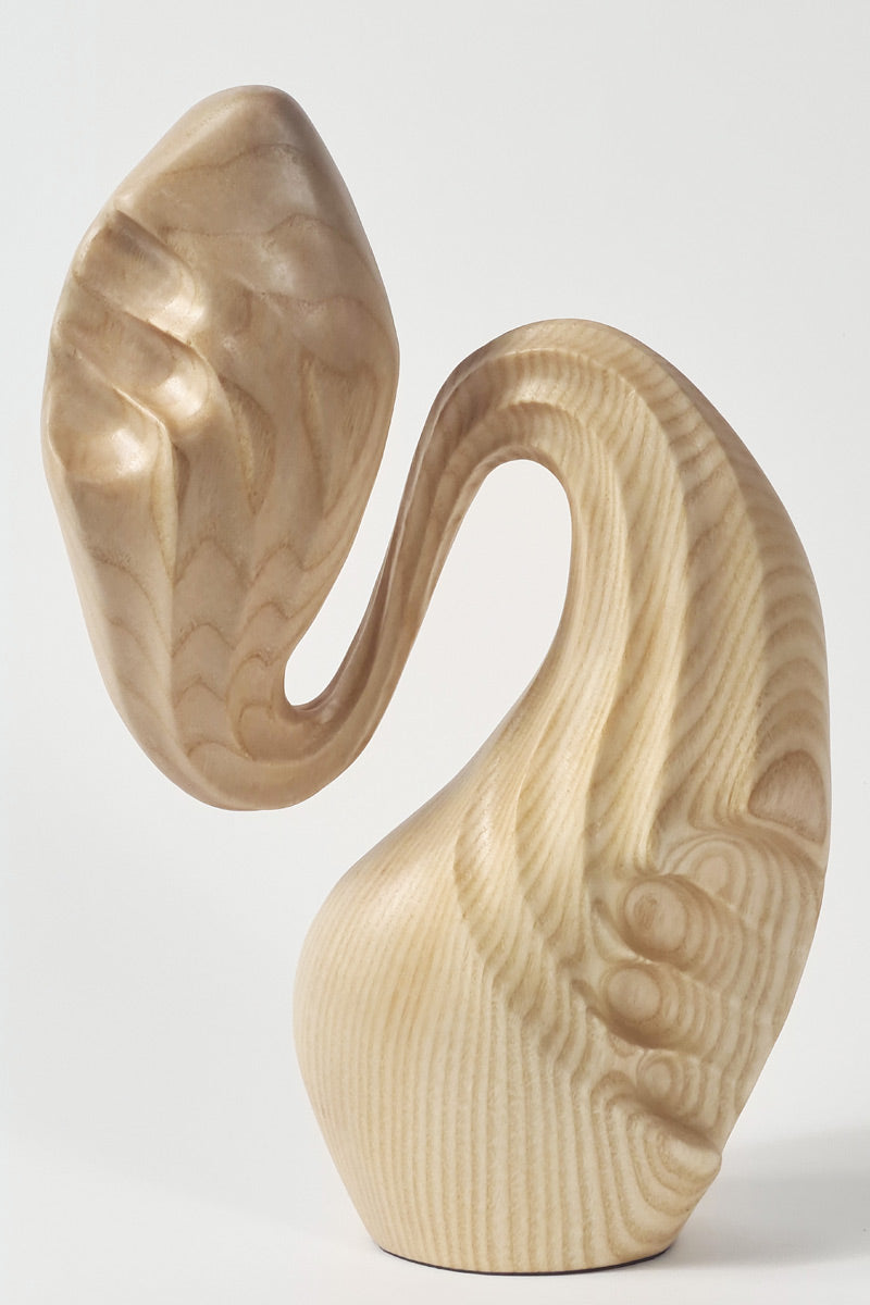 Hand-carved ash wood abstract sculpture with elongated, folded organic forms inspired by stretched sculpting wax and natural movement.