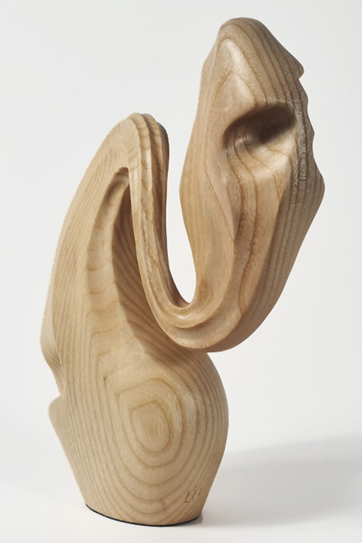 Hand-carved ash wood abstract sculpture with elongated, folded organic forms inspired by stretched sculpting wax and natural movement.