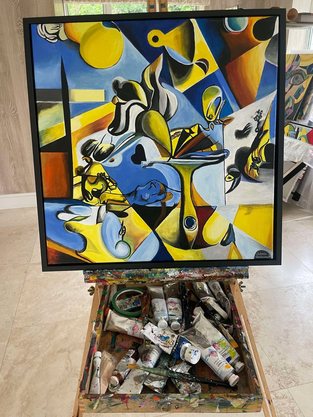 Abstract surrealist painting with bold blue, yellow, and black shapes, featuring distorted figures and dreamlike forms.