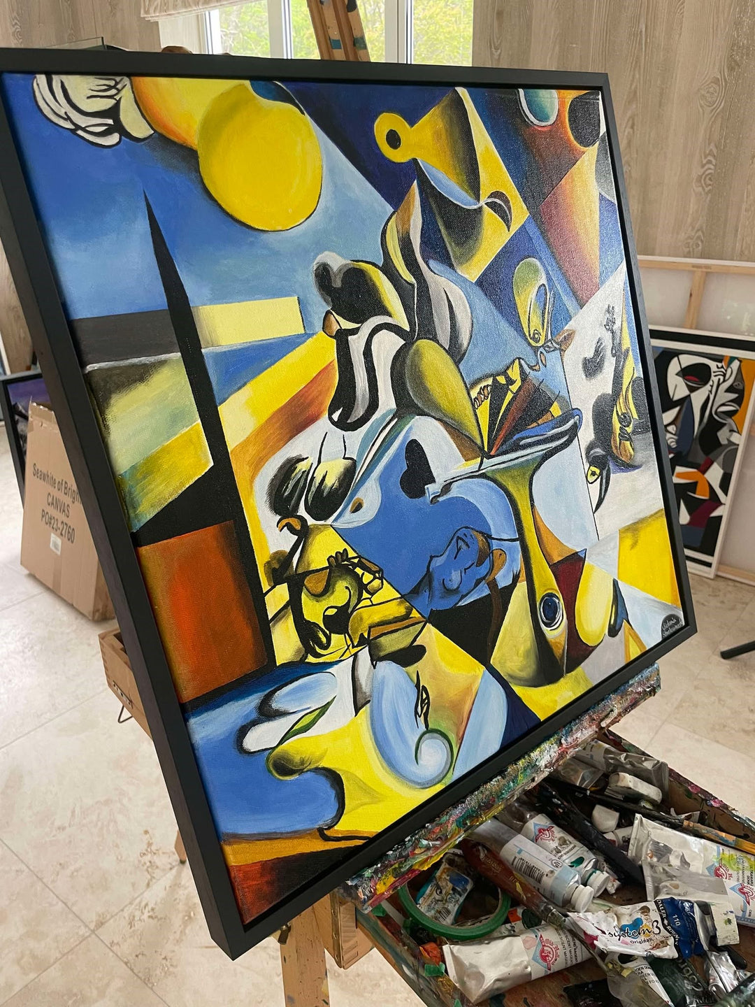 Abstract surrealist painting with bold blue, yellow, and black shapes, featuring distorted figures and dreamlike forms.