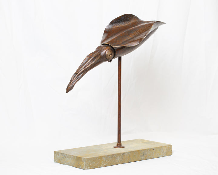Bigfin Reef Squid bronze sculpture by Tom Saxton mounted on a vertical stand and Cotswold stone plinth, elegant marine life sculpture with flowing fins in rich dark bronze and warm copper-brown tones with subtle golden highlights