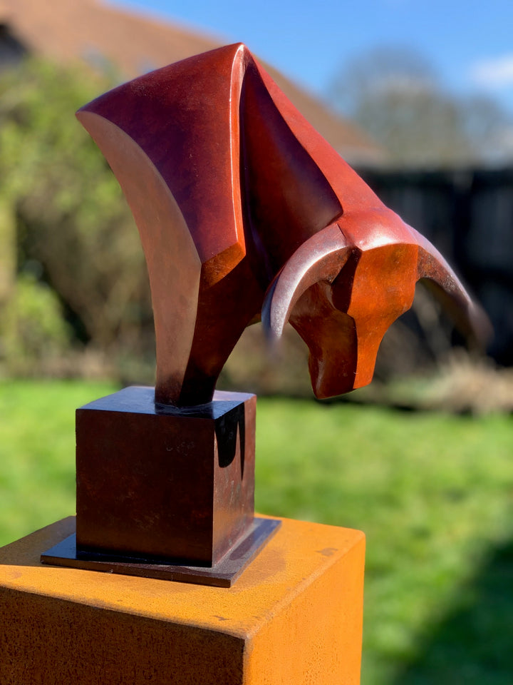 Marie Ackers The Bull’s Head bronze sculpture — stylised abstract bull head with powerful downward stance, geometric lines and deep red patina. Signed, numbered, and foundry stamped with certificate of authenticity.