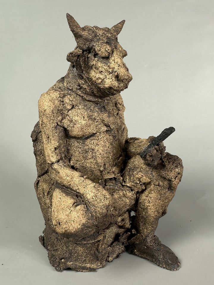 Figurative ceramic sculpture of a crouched animal-like figure absorbed in a mobile phone, exploring modern distraction and isolation, by Eve Shepherd