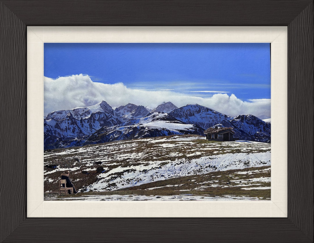 James Earley The Magic Door realism Print depicting a young boy seated alone on a chair overlooking a vast Pyrenean mountain landscape, with snow-covered peaks stretching beneath a deep blue sky. The composition balances solitude and openness, with the small figure placed against an expansive horizon, evoking quiet reflection, emotional release and a sense of escape into nature.