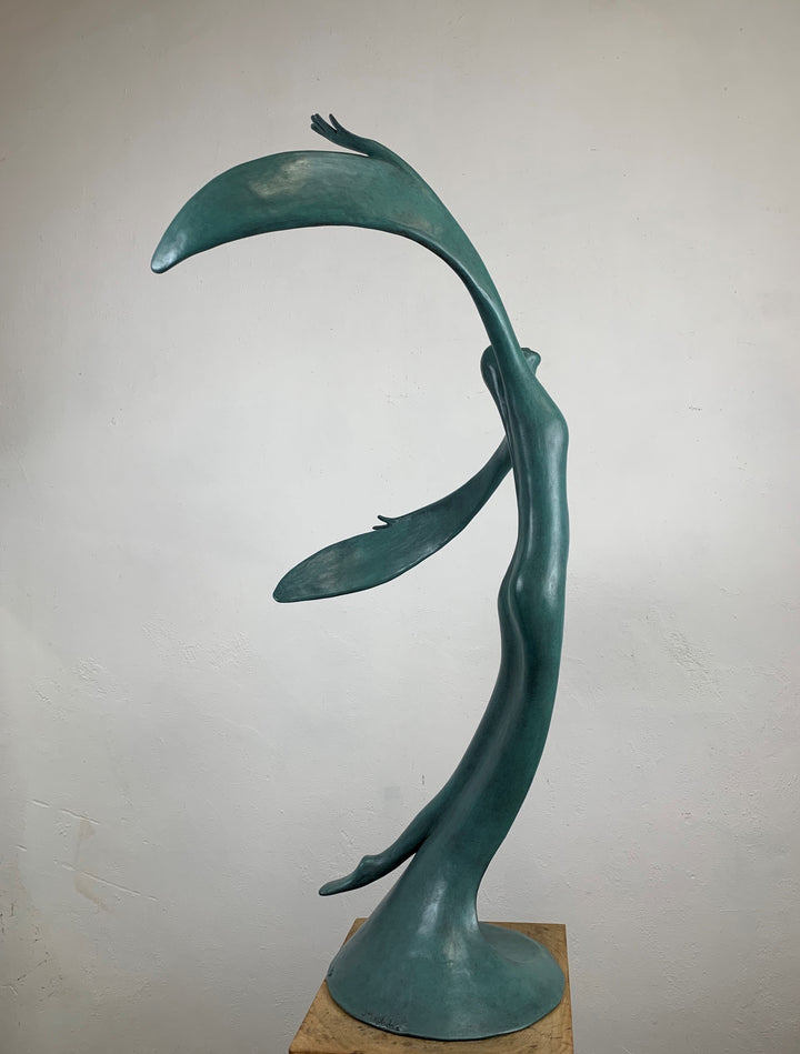 Abstract teal bronze sculpture of a flowing female figure with elongated arms and sweeping wing-like forms, suggesting flight or dance.