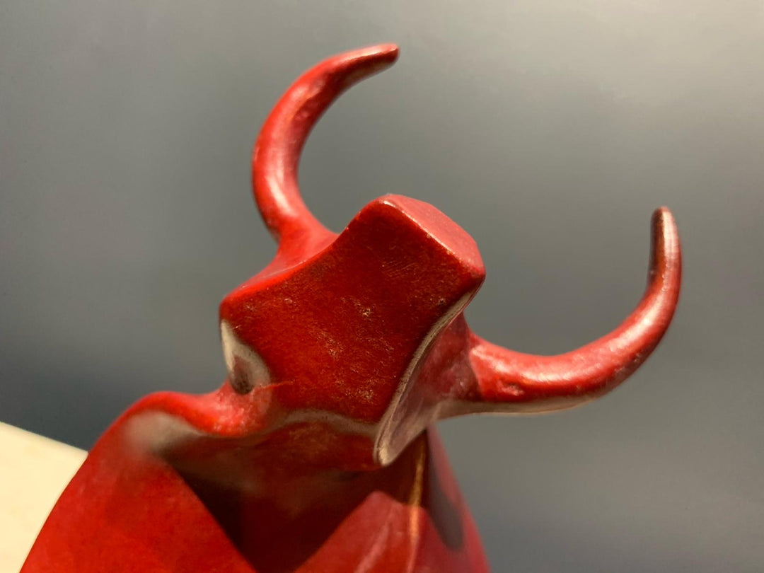 Marie Ackers Small Red Bull bronze sculpture — dynamic, abstract bull with flowing geometric curves and raised horns. Deep red patina. Signed, numbered, and foundry stamped. Scaled version of her Large Red Bull.