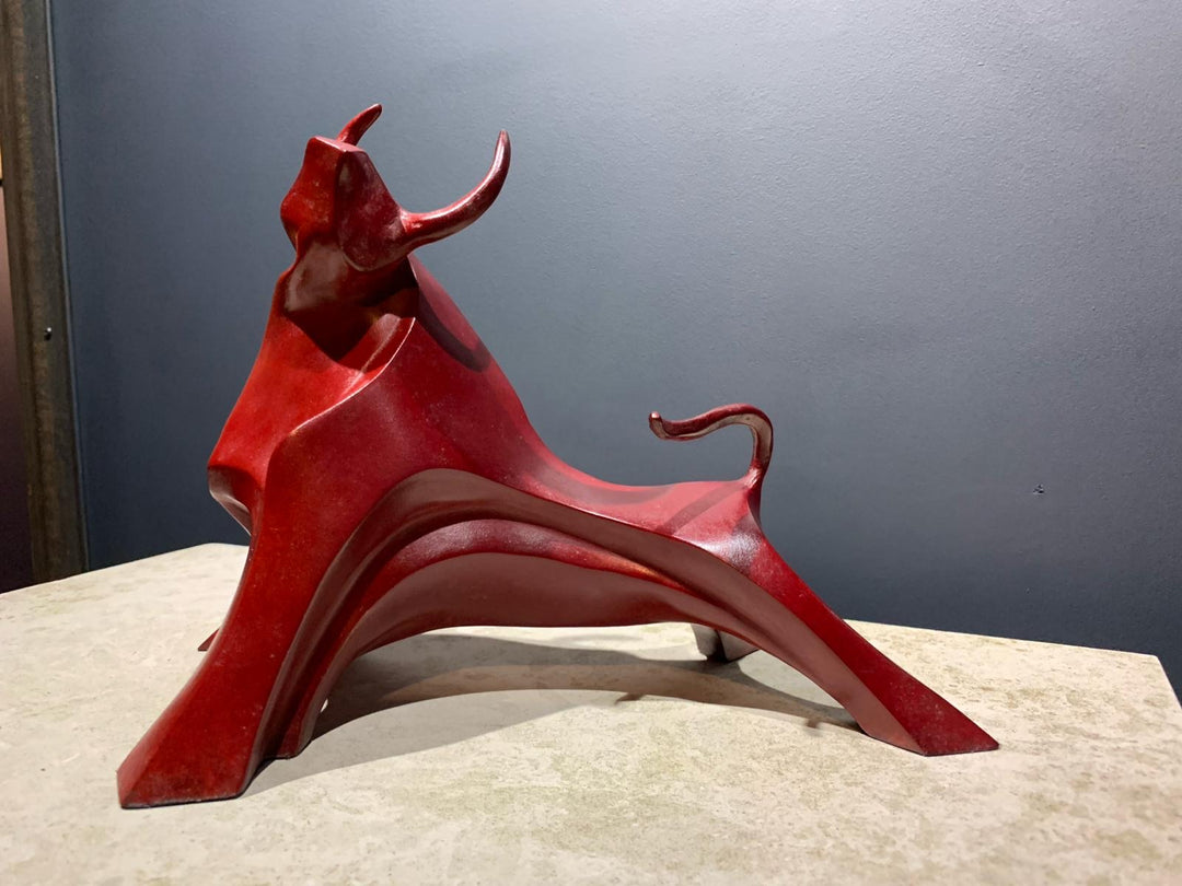 Marie Ackers Small Red Bull bronze sculpture — dynamic, abstract bull with flowing geometric curves and raised horns. Deep red patina. Signed, numbered, and foundry stamped. Scaled version of her Large Red Bull.