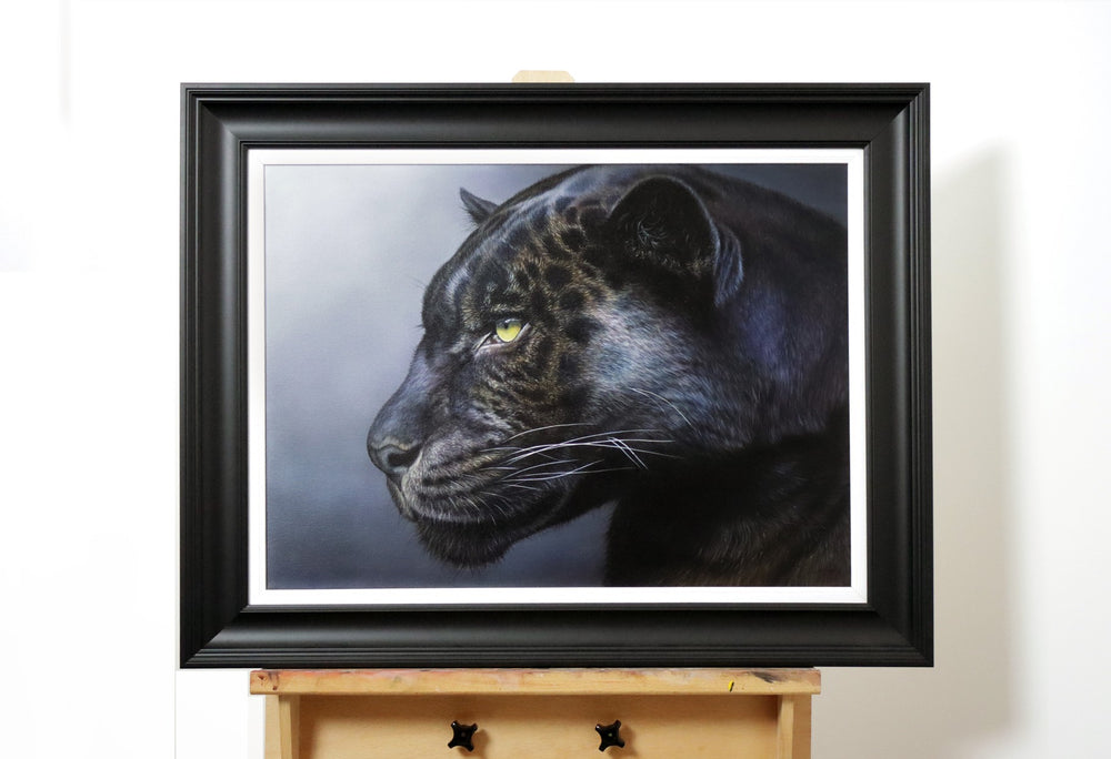 Side profile of a black panther with golden-yellow eyes and faint rosette markings against a soft grey background.