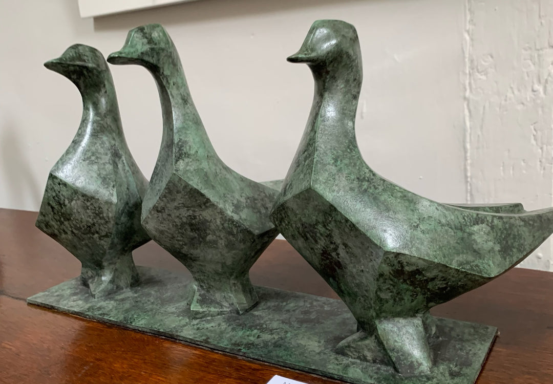 Marie Ackers The Three Geese bronze sculpture in green patina, limited edition. Three stylised geese stand side by side, their simplified forms capturing rhythm, unity, and timeless elegance in contemporary animal sculpture.