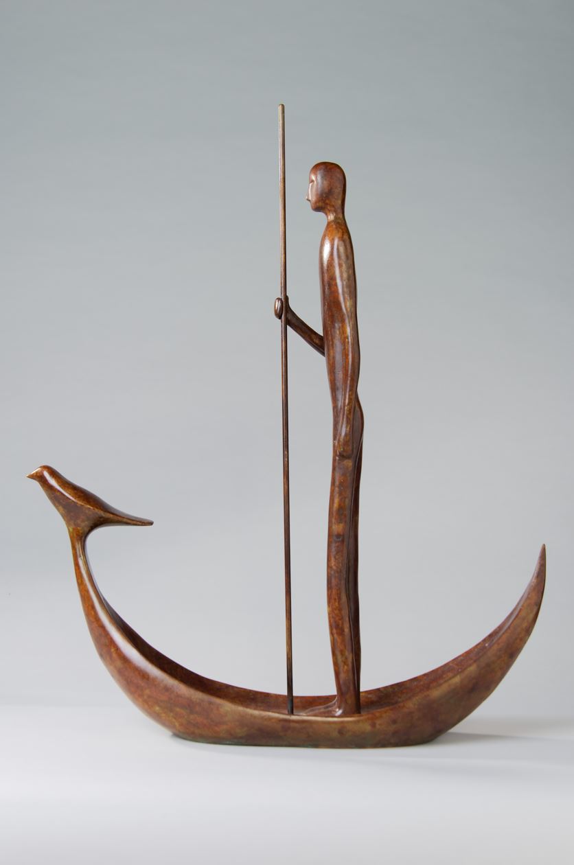 Bronze sculpture of a minimalist figure standing in a stylised crescent boat with a bird at the bow.