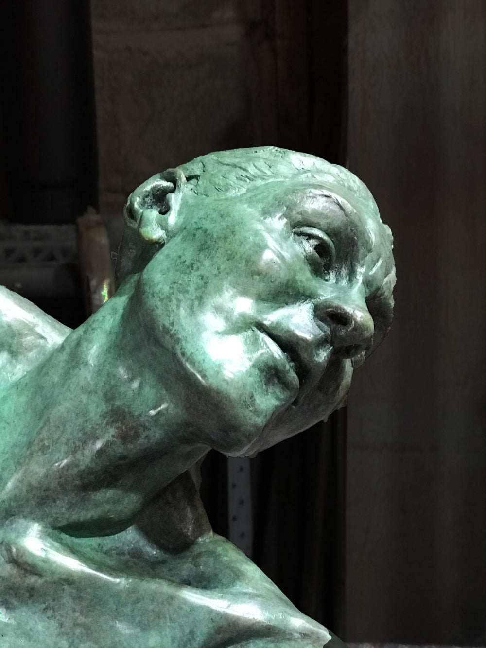 Teresa Wells’ The Wish (2021), limited edition bronze sculpture depicting a seated female figure with one leg folded beneath her and the other extended, torso twisting as she reaches outward with an expressive, outstretched hand. Finished in a mottled green patina with bronze undertones, the piece captures a moment of yearning and emotional intensity, with finely rendered musculature, detailed facial features, and dynamic posture. Measuring 60cm × 37cm × 44cm and weighing 37.3kg.
